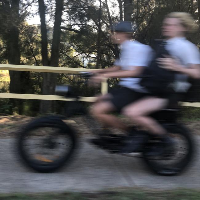 Secondary schools students on an e-bike on Pittwater Rd, Manly. Picture: Jim O'Rourke