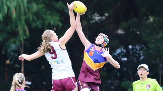 Maddy Pfitzner, left, trains and plays strongly in the ruck.