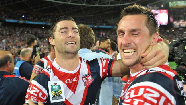 Pearce celebrates winning the 2013 grand final with Anthony Minichiello.