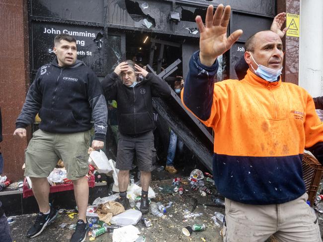 CFMEU members emerge from the headquarters after it was attacked during the protest. Picture: David Geraghty