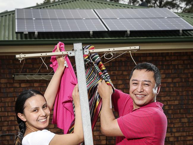 BUSINESS -  Solar Homeowner - Ilhamjan Sabit and his wife Camilla Tursun with their solar panels. Picture SARAH REED