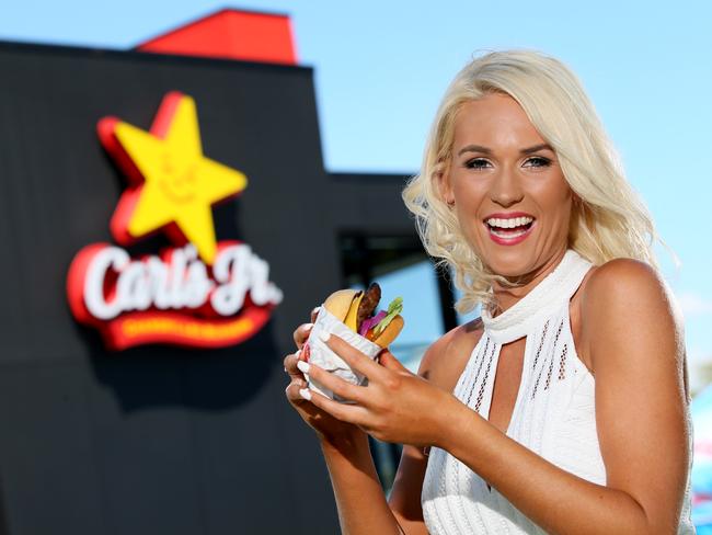 Carl's Jr ambassador, Australian model Gemie Howe with a burger at the launch of Carl's Jr in Australia, at Bateau Bay on the NSW Central Coast. Picture: Troy Snook