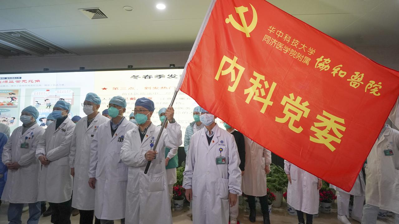 Medical workers in Wuhan participate in a ceremony to form an "assault team" to battle against a coronavirus epidemic. Picture: Cheng Min/Xinhua via AP