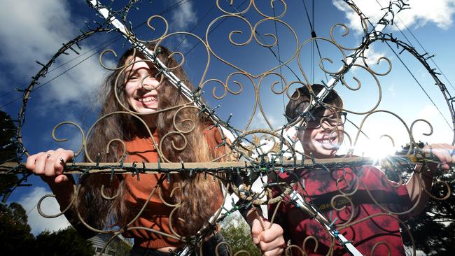 Veronique, 14, and her brother Jean, 11, with a star they've made to illuminate their Montrose street. Picture: Andrew Henshaw