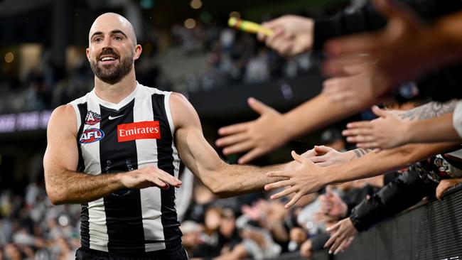 MELBOURNE, AUSTRALIA – APRIL 25: Steele Sidebottom of the Magpies high fives fans after winning the round seven AFL match between Collingwood Magpies and Essendon Bombers at Melbourne Cricket Ground, on April 25, 2025, in Melbourne, Australia. (Photo by Quinn Rooney/Getty Images)