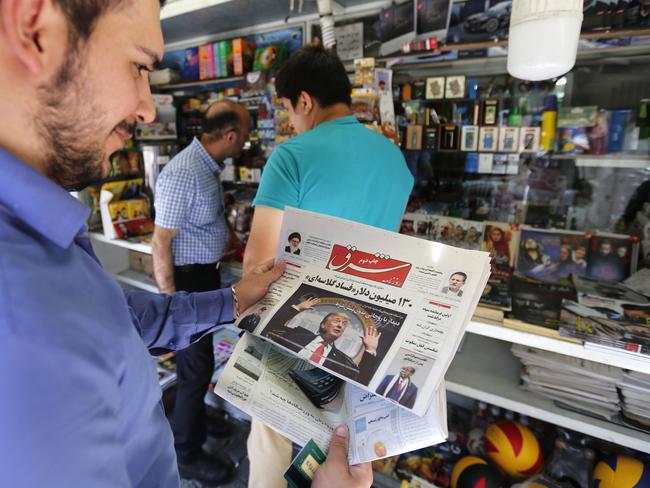 A man takes a glance at a newspaper with a picture of US president Donald Trump on the front page, in the capital Tehran. Picture: AFP