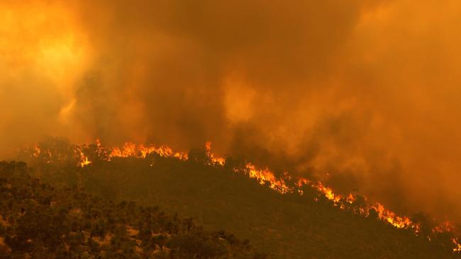 A fire driven by strong winds burns on a ridge in the suburb of Brigadoon in Perth on Tuesday. Picture: AFP