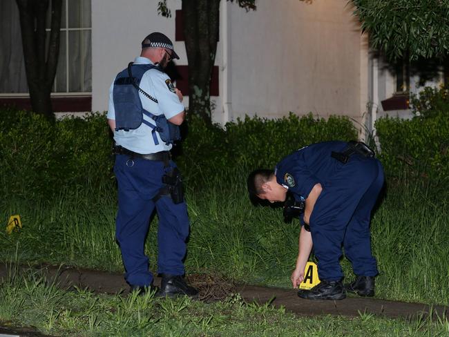 Police collect evidence following the suspected drive-by shooting at Glenwood. Picture: Bill Hearne