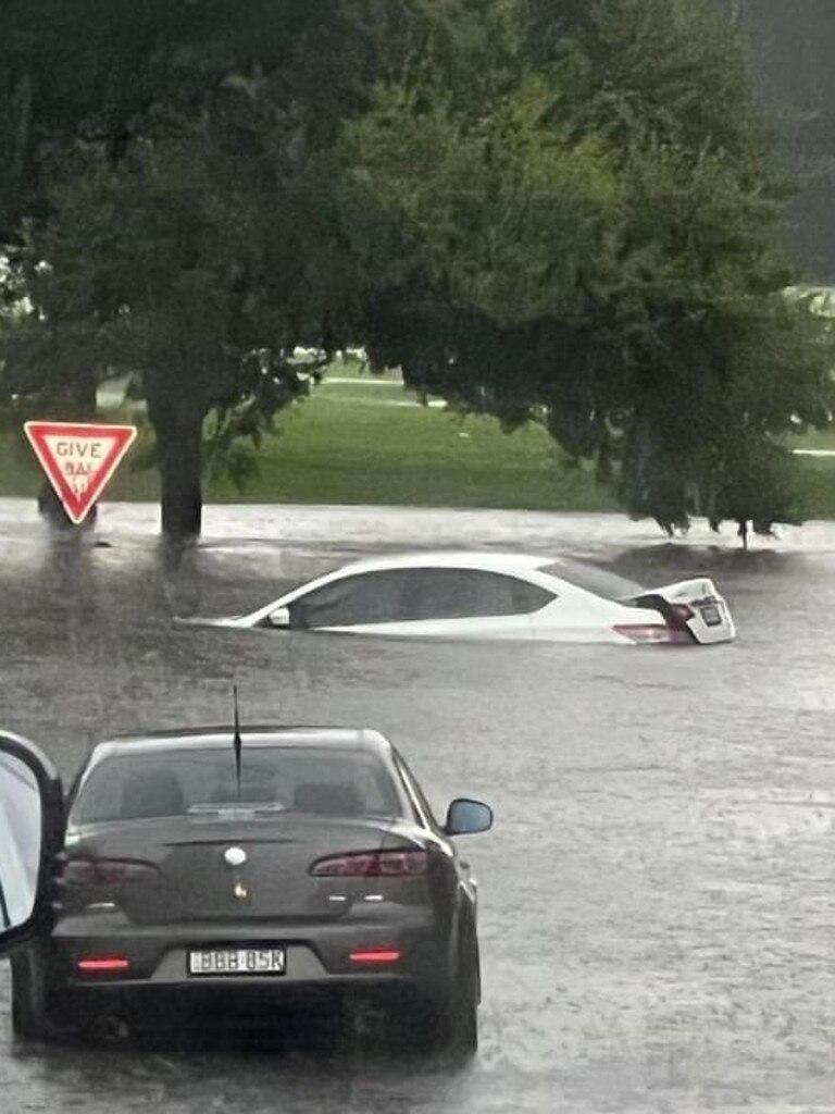 Floodwaters submerged vehicles at Gosford on Friday.