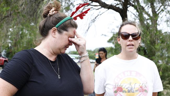 Shae Curr-Parkes and Kate Hammacott become distressed waiting for word from family members stranded by floodwaters at Holloways Beach. Flood water from ex-Tropical Cyclone Jasper on December 18, 2023. Picture: Brendan Radke