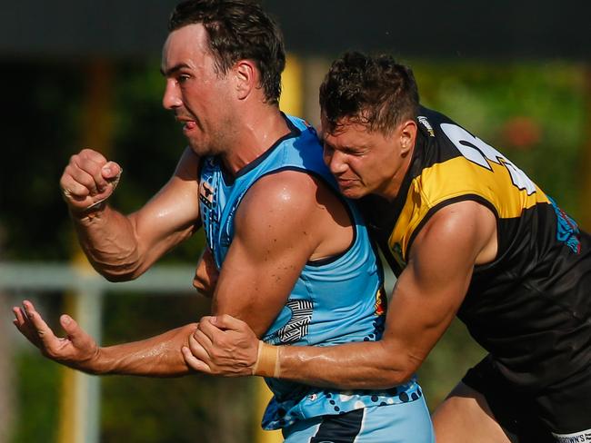 Patrick Boles gets the ball away despite the attentions of Jonathan Peris as Nightcliff V Biffs at Nightcliff Oval.Picture GLENN CAMPBELL