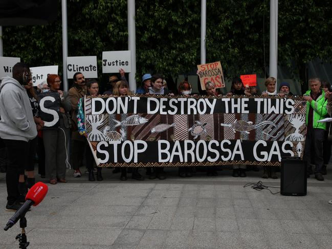 MELBOURNE, AUSTRALIA - NOVEMBER 15: Protesters hold a banner at the front of the Federal Court Of Australia on November 15, 2022 in Melbourne, Australia. The Federal Court is hearing an appeal by Santos Ltd., which seeks to restart drilling in the Barossa Gas project, located near the Tiwi Islands off the northern coast of Australia. Courts had earlier ruled the approval for drilling in the project as invalid. (Photo by Tamati Smith/Getty Images)