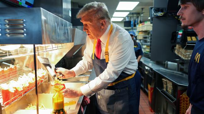 Donald Trump works behind the counter making French fries during a visit to McDonald's in Feasterville-Trevose, Pennsylvania. Picture: Getty Images.