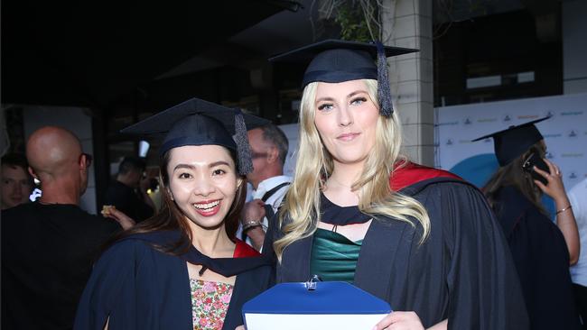 Hanh Nguyen and Kealey Rouse celebrate graduation. Picture: Alan Barber