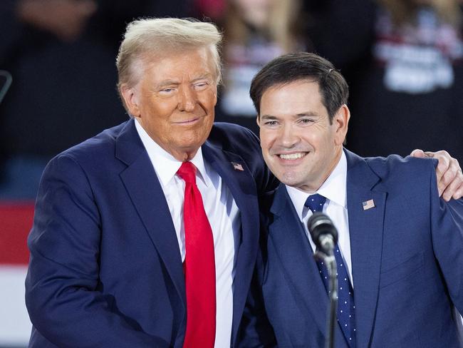 (FILES) Former US President and Republican presidential candidate Donald Trump greets Senator Marco Rubio, Republican of Florida, during a campaign rally at the J.S. Dorton Arena in Raleigh, North Carolina, on November 4, 2024. President-elect Trump is expected to name Rubio as secretary of state, The New York Times reported late on November 11, 2024. It quoted three people as saying that the decision is not final, but that Trump appears to have settled on Rubio, a loyalist whom Trump passed over as his vice presidential running mate. (Photo by Ryan M. Kelly / AFP)