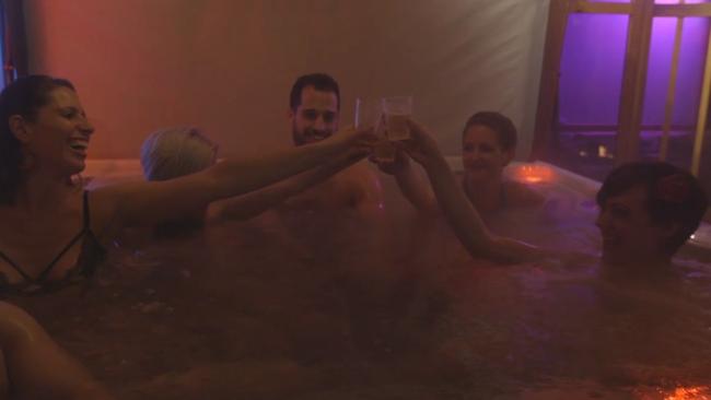 Scantily clad 20-somethings enjoy a glass of bubbly in the hot tub. Picture: New York Post