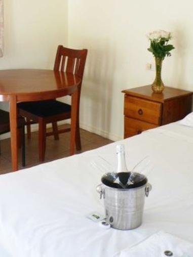 The rooms, with a bottle of wine, as advertised on the website. Picture: Supplied