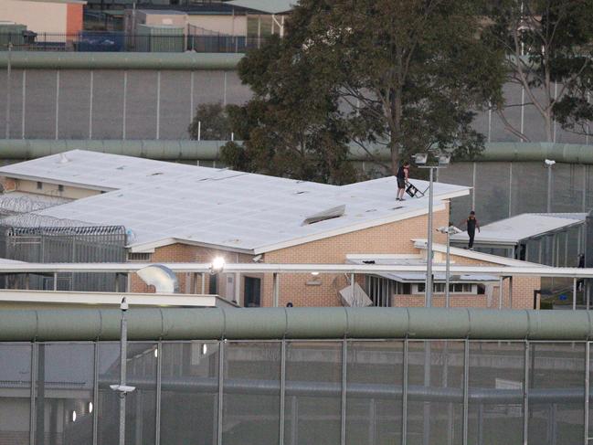 Two males on the roof of the Cobham Juvenile Justice Centre at Werrington.