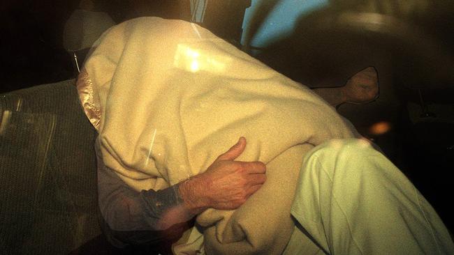 Colin Fisk covers his face after leaving the NSW Police Royal Commission in 1996. Picture: Supplied