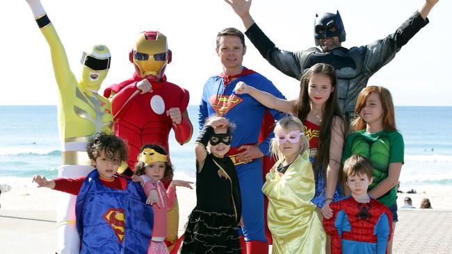 A group taking part in the Superhero Walk in 2016 founded by Maroubra local Tasman Cassim (superman).