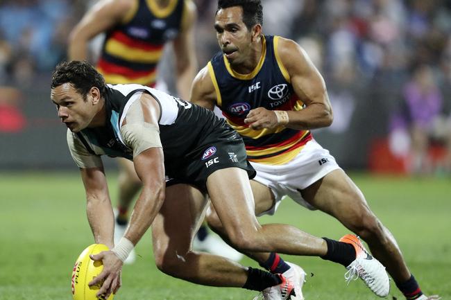 Port Adelaide’s Steven Motlop gathers the football in front of Crows Eddie Betts in Showdown 46 at Adelaide Oval. . Picture Sarah Reed