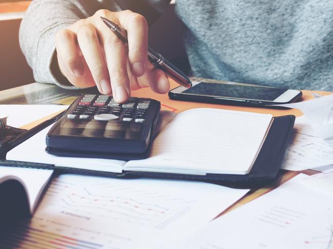 Man using calculator and calculate bills in home office.