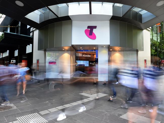 Pedestrians walk past a Telstra Corp. Discovery store in Melbourne, Australia, on Tuesday, Feb. 9, 2016. Telstra, Australia's biggest phone company, is scheduled to report half-year results on Feb. 18. Photographer: Carla Gottgens/Bloomberg