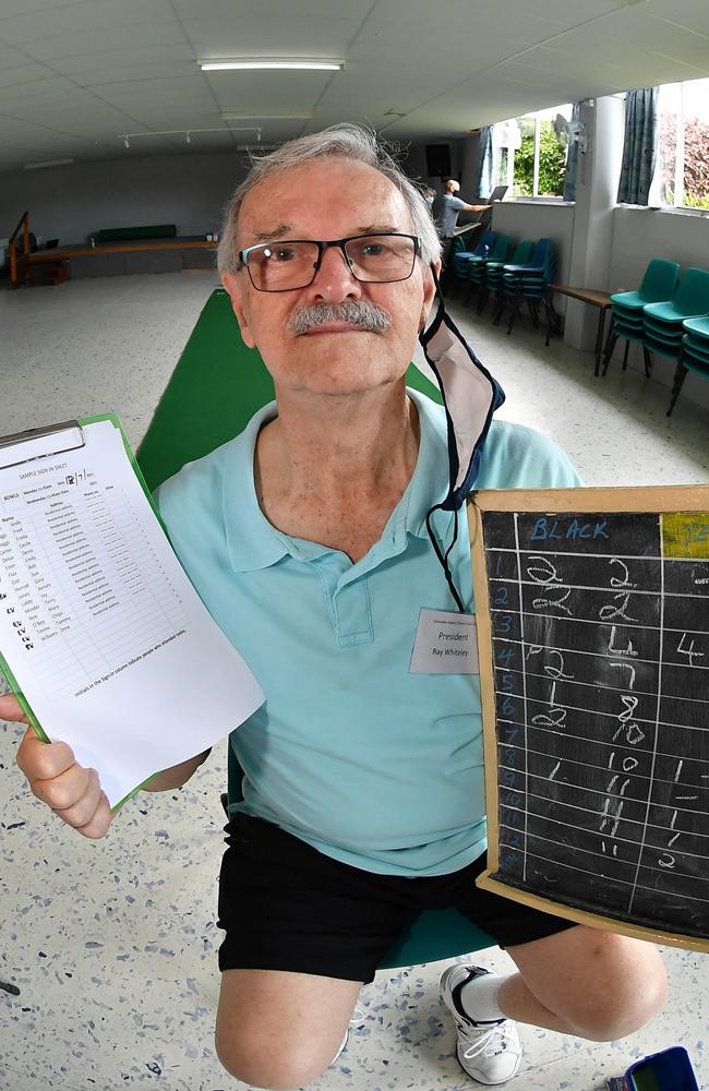 Ray Whiteley with their manual check-in papers. Picture: Patrick Woods