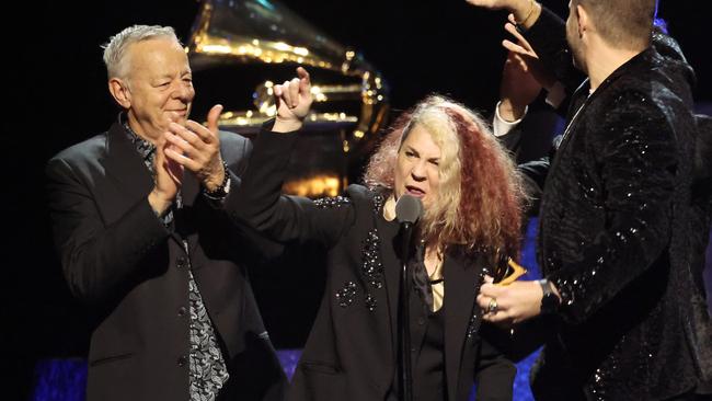 Tommy Emmanuel, Janet Robin, and Markus Illko accept the best arrangement, instrumental or a capella award for Folsom Prison Blues. Picture: Amy Sussman/Getty Images