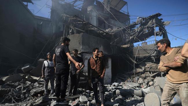 People inspect the debris a day after an Israeli airstrike. Picture: AFP