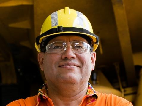 BHP Minerals Australia President Edgar Basto in front of a Komatsu haul truck at Goonyella Riverside Mine