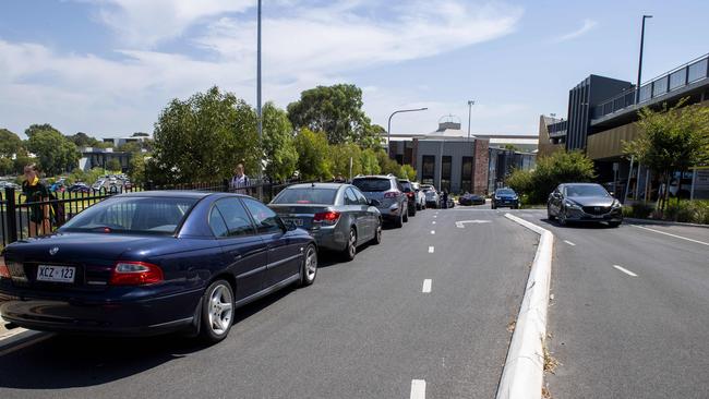 Parents line-up to pick up their children at the Golden Grove High school pick-up zone. Picture: Mark Brake