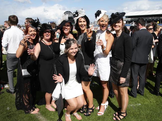 Race goers enjoy the atmosphere on Victoria Derby Day at Flemington Racecourse on Saturday, November 1, 2014, in Flemington, Australia. Picture: Hamish Blair