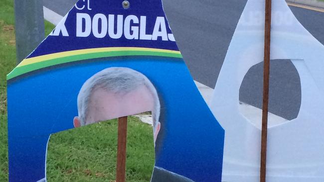 Election signs in Gaven continue to be defaced in the lead-up to Saturday's poll. Sitting member Alex Douglas's face has been cut out of these signs at Nerang.