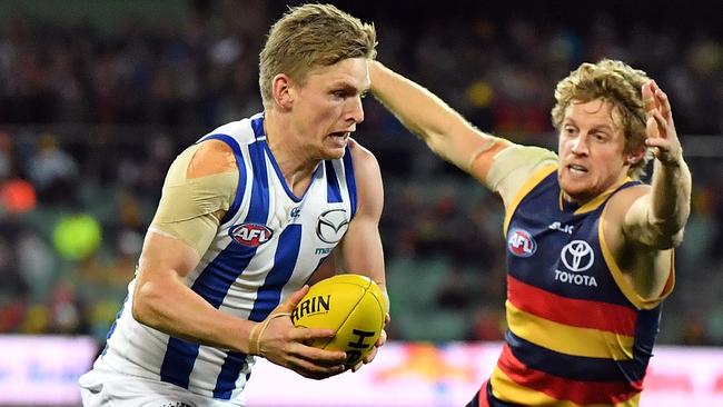 Jack Ziebell tries to evade a tackle by Rory Sloane.