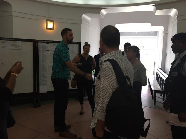 John and Yvette Nikolic exiting the court house for a recess before resuming to the hearing at the Suva High Court. They are seem shaking hands with a man from the Australian Embassy (green shirt) Picture: Varanisese Bolatagane