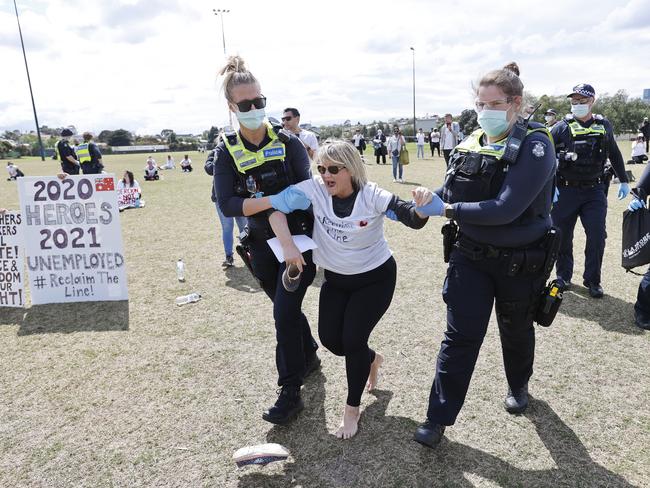 Police take a women into custody. Picture: Alex Coppel