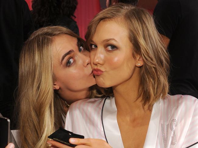 Models Cara Delevingne and Karlie Kloss pose at the 2013 Victoria's Secret Fashion Show.
