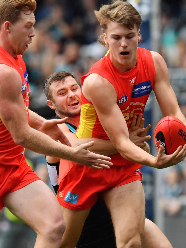 Charlie Ballard of the Suns is tackled by Sam Gray of the Power during the Round 9 AFL match between the Port Adelaide Power and the Gold Coast Suns at the Adelaide Oval in Adelaide, Sunday, May 19, 2019. (AAP Image/David Mariuz)