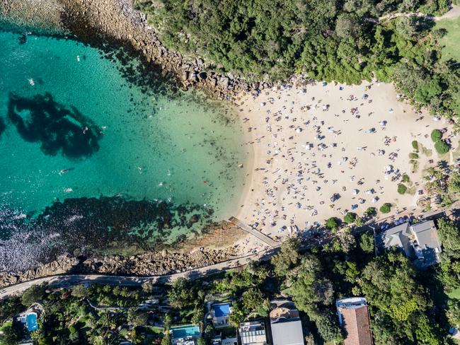 Panoramic aerial bird's eye view of Shelly Beach at the southeastern end of Manly, a beachside suburb of Sydney, New South Wales, Australia. Hot summer day with many people on the beach enjoying sun.Photo - iStockESCAPE 20 MARCH 2022savvy