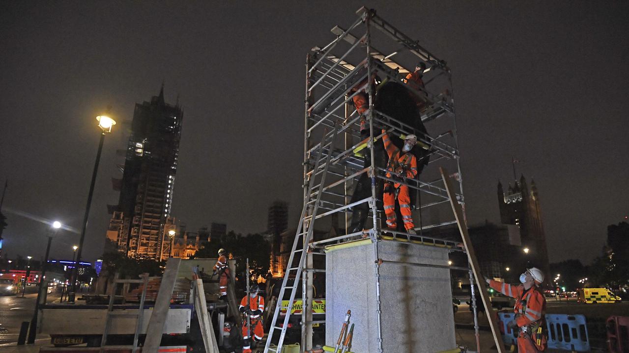 Scaffolders worked through the night to cover the statue. Picture: Kirsty O'Connor/PA via AP