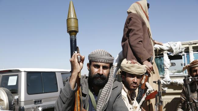 Houthi weaponized followers ride a vehicle while taking part in a tribal rally and parade denouncing the US-led aerial attacks on Yemen.