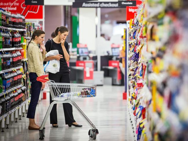 Shoppers browse in an aisle inside a Coles supermarket, operated by Wesfarmers Ltd., in Sydney, Australia, on Tuesday, Feb. 18, 2014. Wesfarmers, Australia's largest employer, is scheduled to report first-half earnings on Feb. 19. Photographer: Ian Waldie/Bloomberg via Getty Images