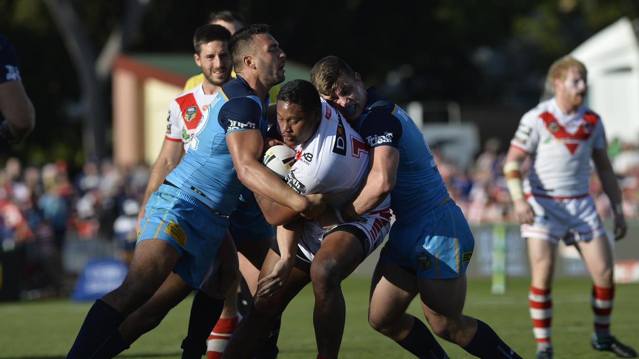 Gold Coast Titans captain Ryan James (left) wraps up his St George Illawarra Dragons opponent. Picture: Kevin Farmer