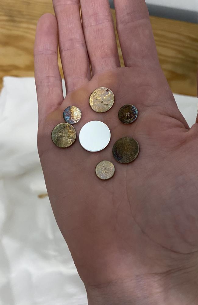 Sterling silver pendants left on workshop benches at a Northgate business have turned black overnight, believed to be due to the strong presence of hydrogen sulphide gases in the air. Picture: Supplied