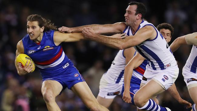 Marcus Bontempelli pushes off North Melbourne’s Todd Goldstein. Picture: Michael Klein