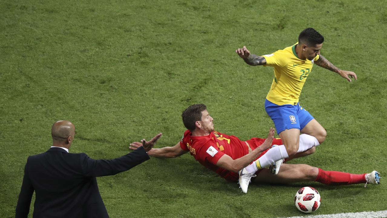 Belgium coach Roberto Martinez gestures as Belgium's Jan Vertonghen tackles Brazil's Fagner