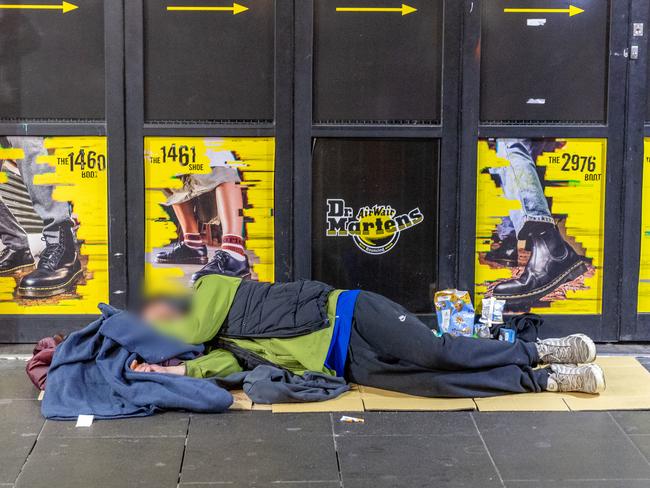 A man sleeps rough on Swanston St. Picture: Jake Nowakowski