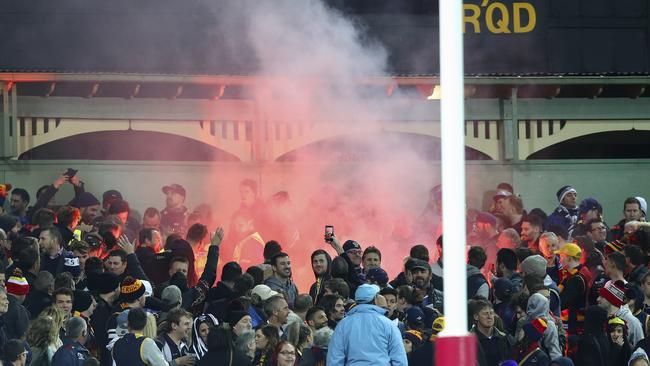 AFL fan behaviour has become of greater concern in recent seasons — and deserves more debate to protect well-behaving fans from flares, as seen at Adelaide Oval last season during the Crows-Geelong match. Picture: Sarah Reed