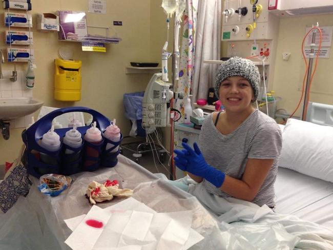 Sophie Kyprianou, pictured playing with tie die in hospital, was just 14 when she was first diagnosed with cancer. Picture: Supplied via NCA NewsWire